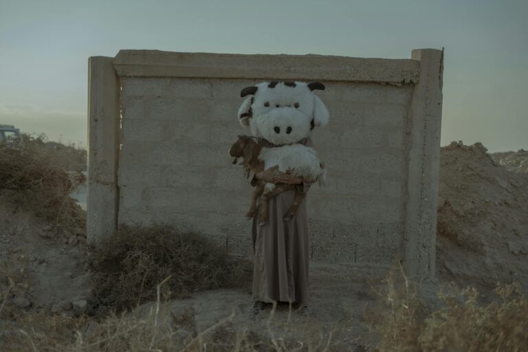 Performer in Costume Holding Goat